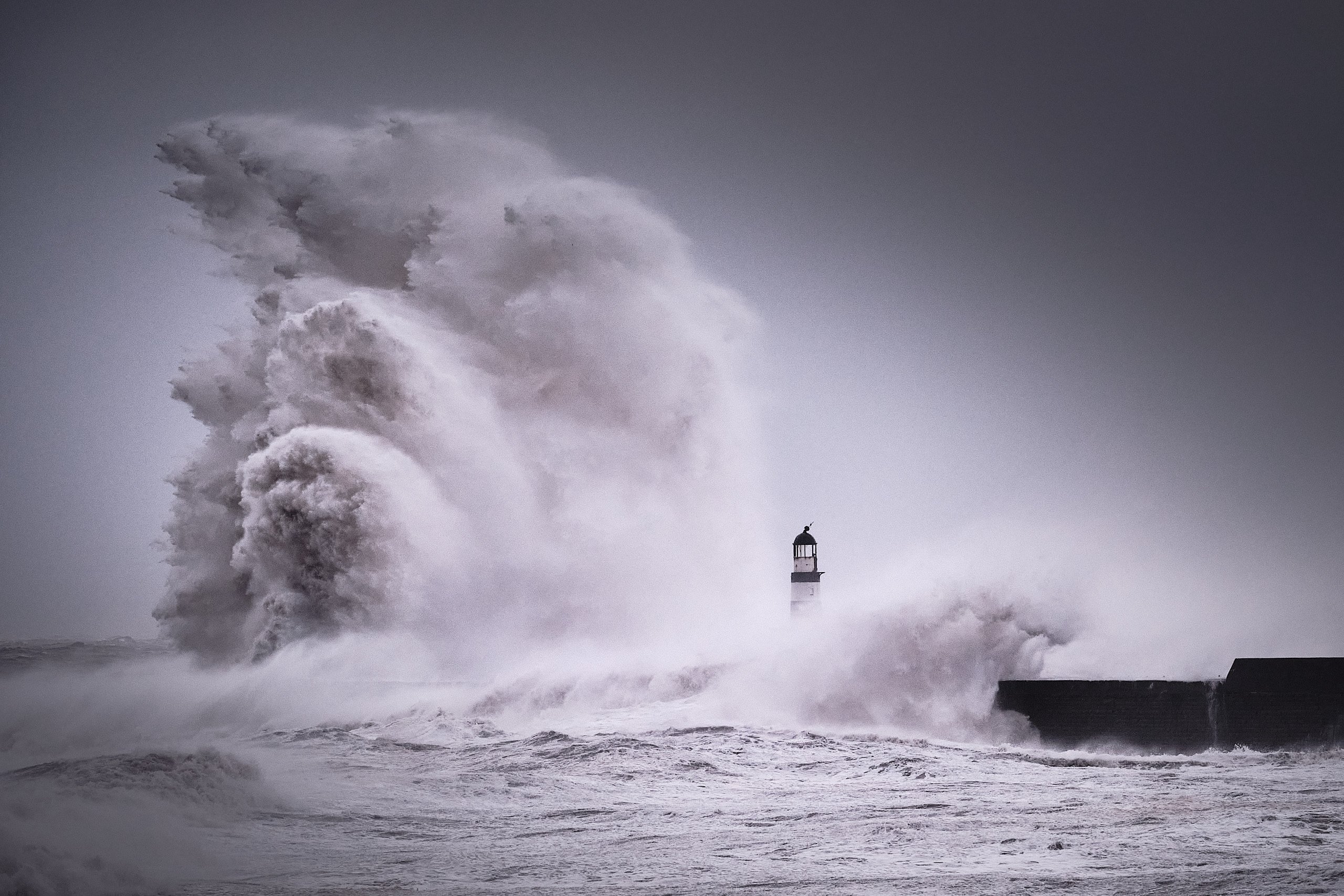 Huge storm waves crashing over Seaham Pier lighthouse during Storm Arwen