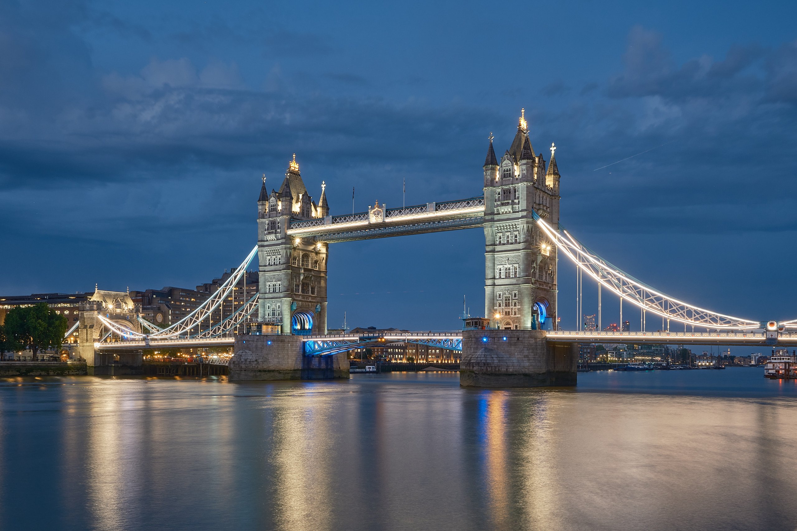 Tower Bridge illuminated over the Thames during blue hour